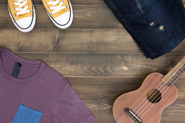 A close-up shot of various streetwear garments laid out on a table, including hoodies, jackets, flannels, and t-shirts, displaying the textures and colors that work well together in a layered outfit.