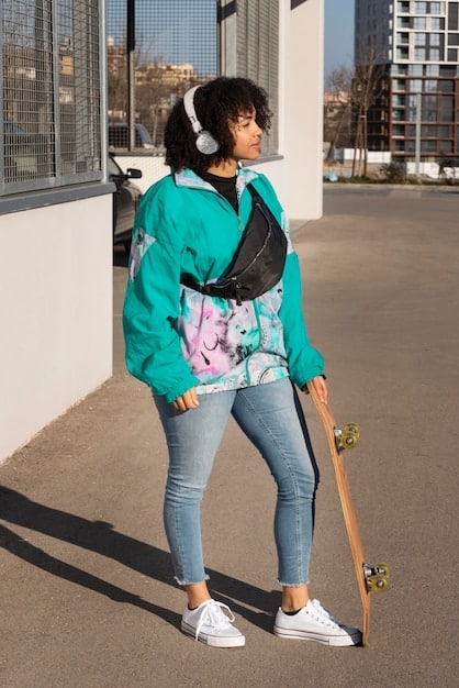 A person wearing a well-fitted streetwear outfit which includes a graphic hoodie, cargo pants, and a stylish beanie. The beanie is brightly coloured and adds a contrast to the rest of the outfit, highlighting the importance of headwear in streetwear fashion.