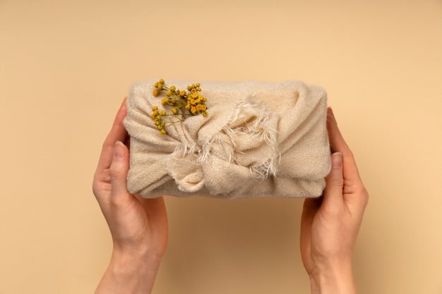 Close-up shot of a hand holding a garment made from organic cotton, showing the texture and natural fibers of the fabric. The background is blurred to focus on the material itself.