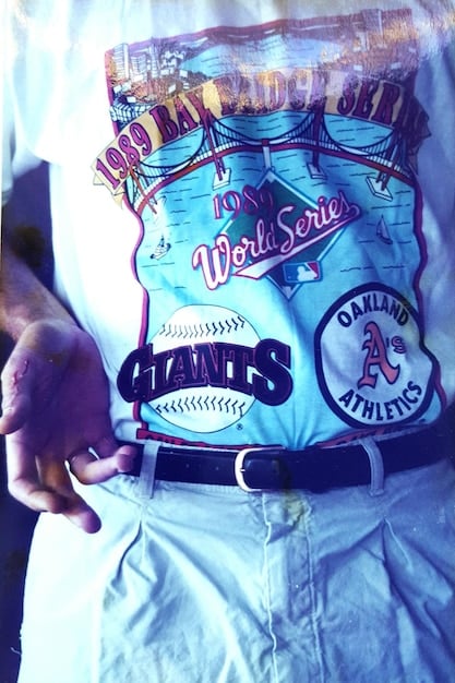 A close-up shot of a vintage Stüssy t-shirt with a bold graphic print, showcasing the brand's early surf and skate-inspired aesthetic. The image should highlight the texture and design of the fabric.