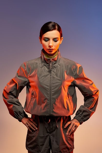 A close-up shot of a woman wearing an oversized hoodie with bold graphic prints, paired with stylish sneakers and statement jewelry, highlighting the blend of comfort and individuality.