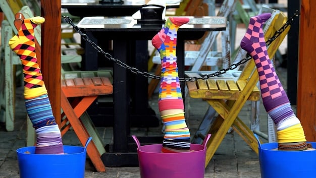 A close-up shot of various pairs of statement socks displayed on a rack in a trendy boutique, highlighting different patterns, colors, and textures.
