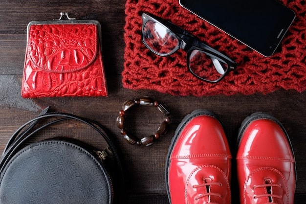 A close-up shot of various accessories that can easily transition an outfit from day to night, such as a statement necklace, a bold belt, a pair of sparkly earrings, and a silk scarf. The items are arranged on a textured surface to give a tactile feel.