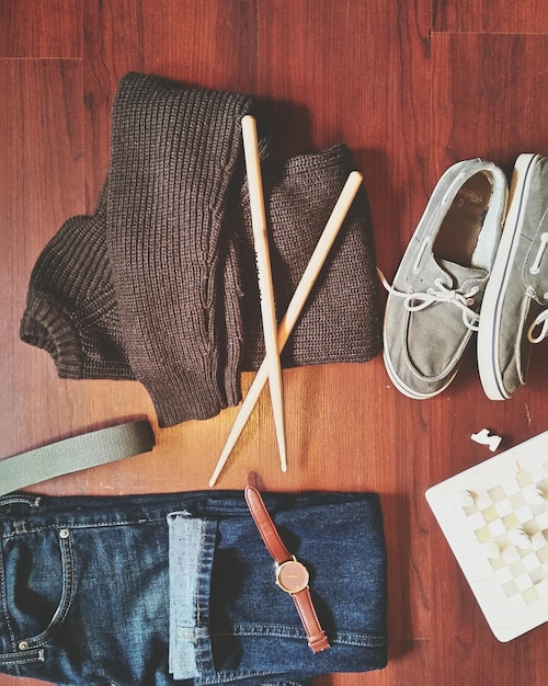 A well-organized closet featuring versatile urban style pieces, including neutral-colored tops, dark denim jeans, a leather jacket, a blazer, and various accessories like scarves, belts, and jewelry. The closet is well-lit, and the items are arranged neatly, showcasing how to build a functional and stylish wardrobe.