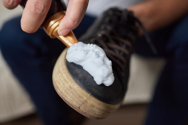 A person carefully cleaning the sole of a sneaker with a brush and cleaning solution. The focus is on the detail of the sole and the cleaning process.