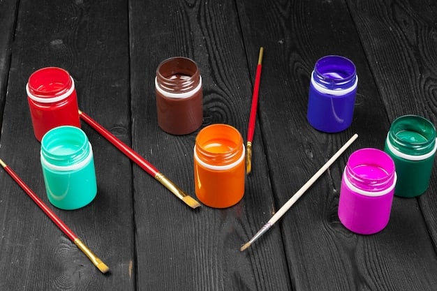 A set of various-sized paint brushes and colorful paint jars neatly arranged on a table, next to a partially customized sneaker with intricate details. This setup showcases the essential tools of the trade.