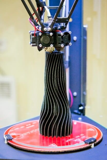 A detailed shot of a 3D printer nozzle extruding a flexible, intricate filament onto a fabric base, symbolizing the blend of traditional textiles with advanced manufacturing, perhaps with a subtle glow hinting at the technology.