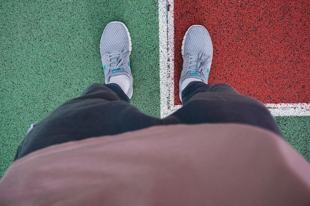 A close-up shot of a man's lower half, showing a pair of the 'Neo-Retro Runner' sneakers paired with perfectly tailored, slightly cropped trousers and patterned socks, demonstrating attention to detail and harmonious color coordination.