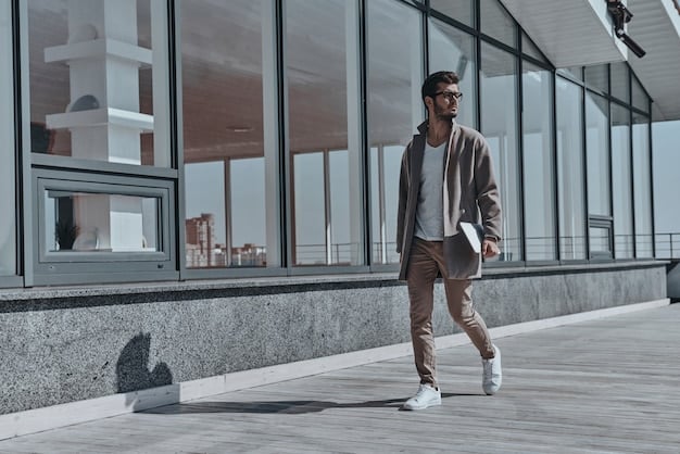 A stylish man walking with the 'Minimalist Tech-Canvas' sneakers, wearing perfectly draped wide-leg trousers and a sophisticated oversized blazer, showcasing a modern, clean, and minimalist aesthetic.